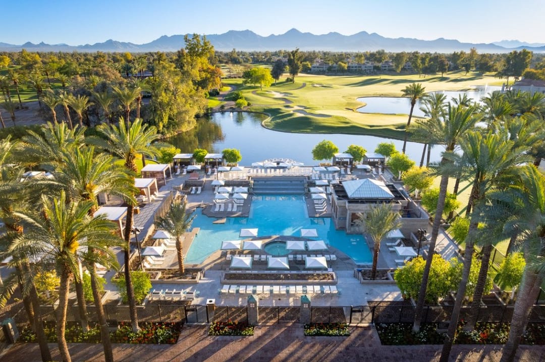 Grand Hyatt Scottsdale pool, cabanas and palms from above, golf course and mountains behind