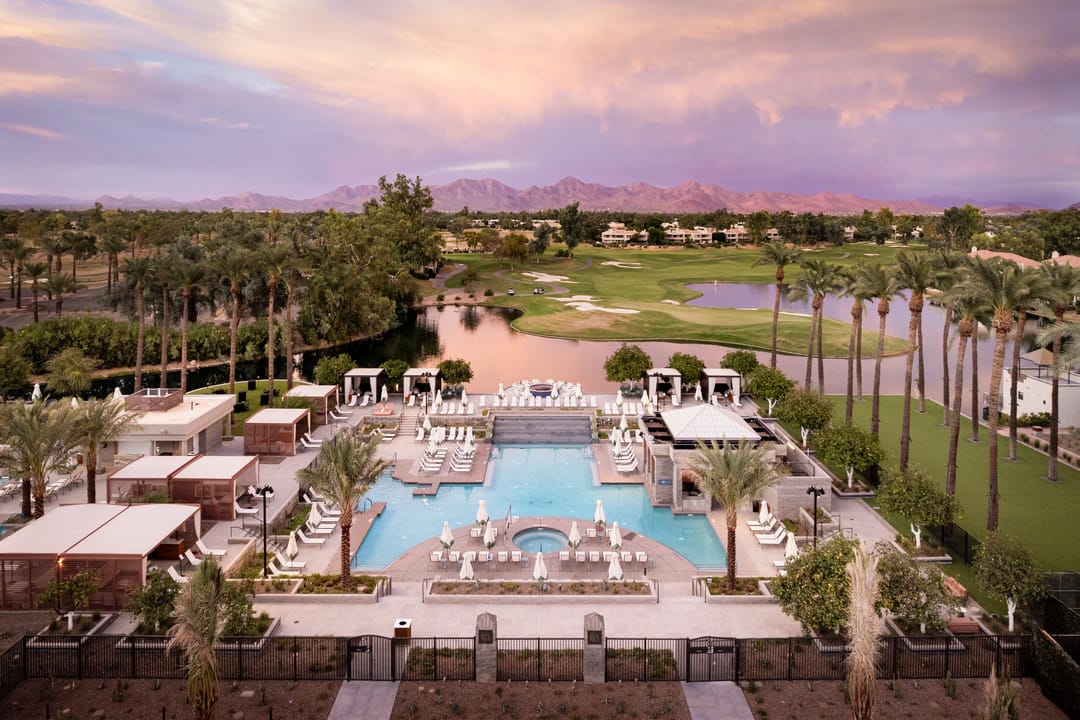 Grand Hyatt Scottsdale pool at sunset, golf course and mountains behind