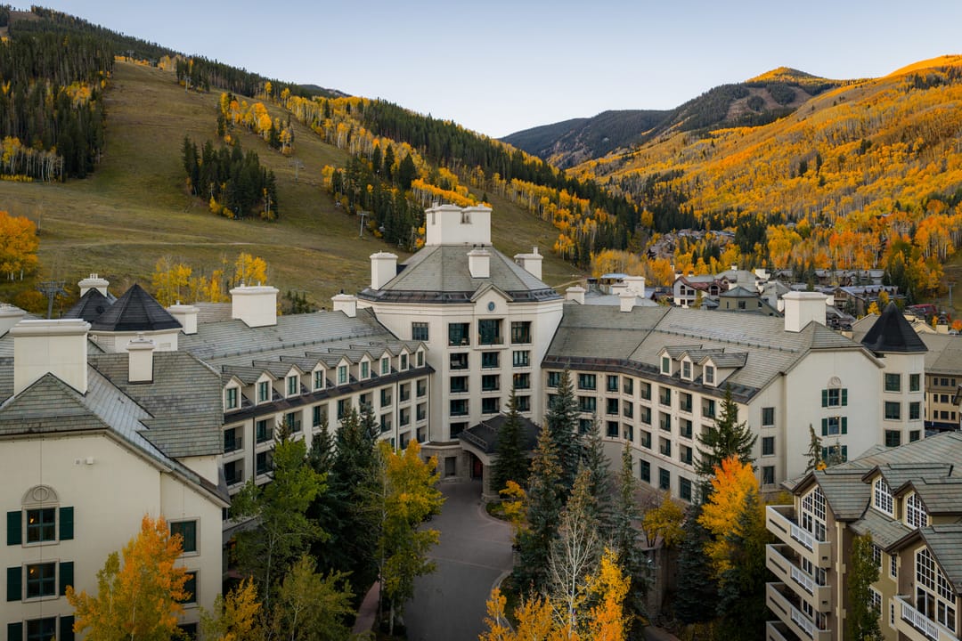 Park Hyatt Beaver Creek from above in fall, gold aspens on the ski slopes behind