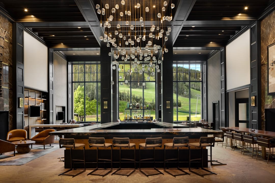Bar under a glass chandelier, tall windows onto the mountain, Park Hyatt Beaver Creek