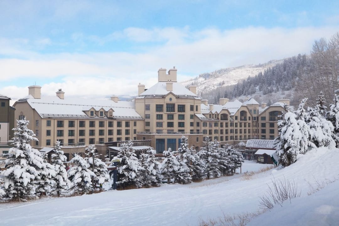 Park Hyatt Beaver Creek under fresh snow, snow-laden pines in front
