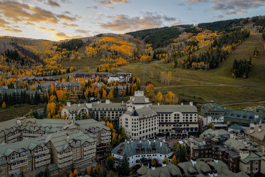 Park Hyatt Beaver Creek and the village from above in fall, gold aspens on the slopes